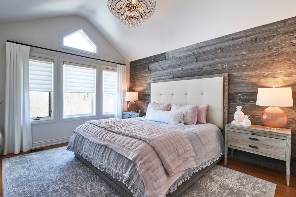 Photo of a country bedroom in Toronto with white walls and brown floor.