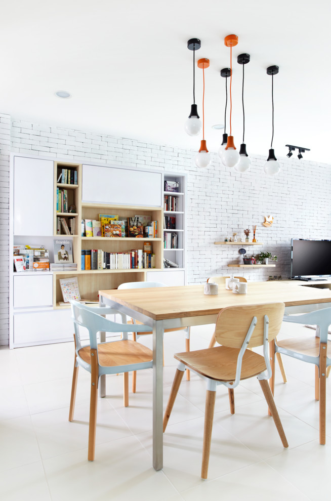 This is an example of a mid-sized contemporary dining room in Singapore with white walls.