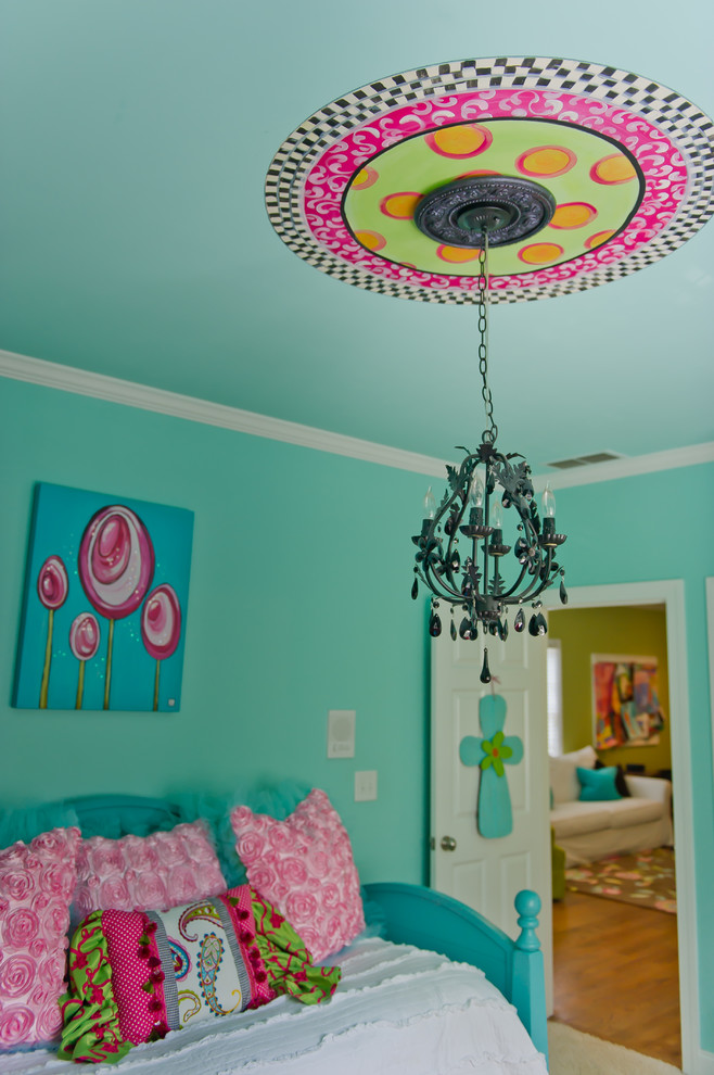 Eclectic girl medium tone wood floor kids' bedroom photo in Atlanta with blue walls