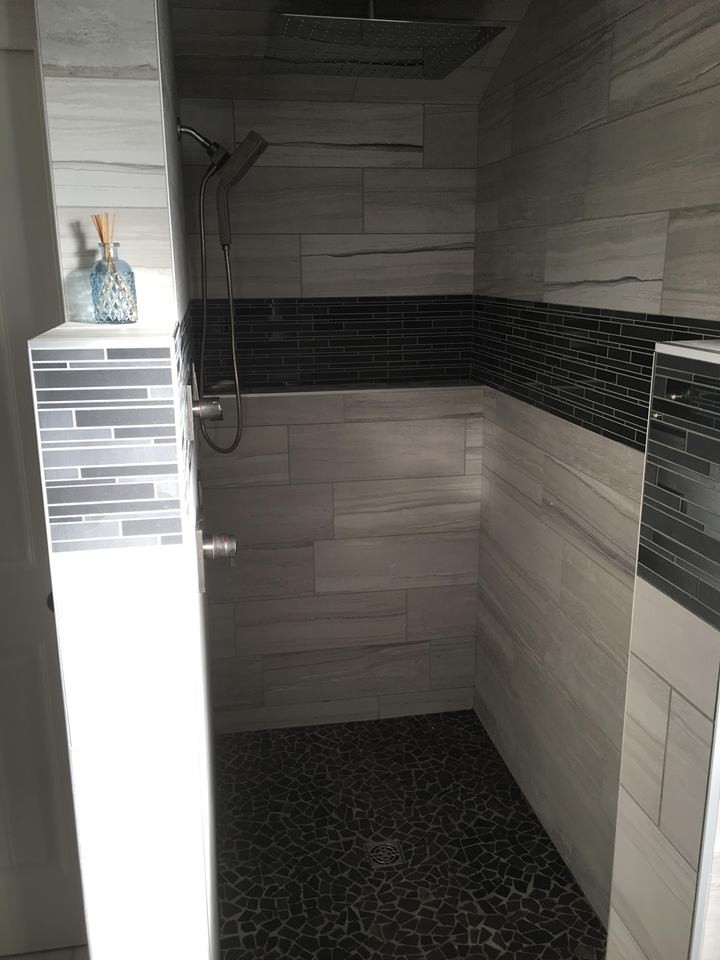 Alcove shower - mid-sized transitional master multicolored tile and matchstick tile vinyl floor alcove shower idea with shaker cabinets, black cabinets, gray walls, an undermount sink and marble countertops