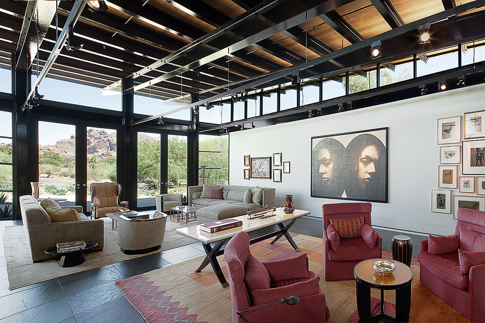 Inspiration for an expansive modern open concept living room in Phoenix with grey walls and slate floors.