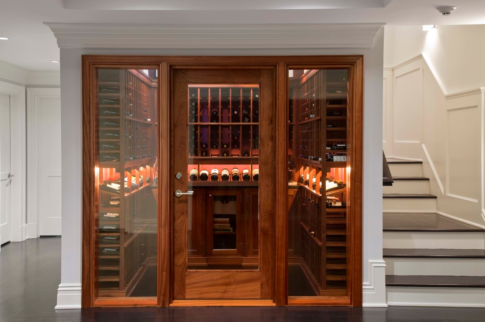 Design ideas for a small traditional wine cellar in New York with display racks and black floor.