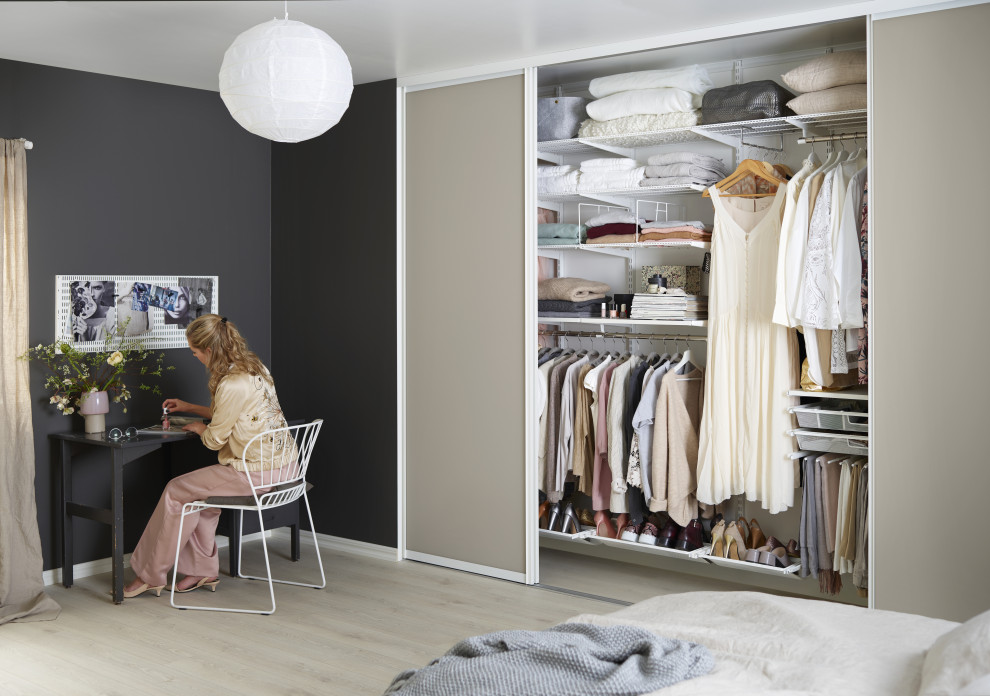 Mid-sized minimalist bedroom photo in London