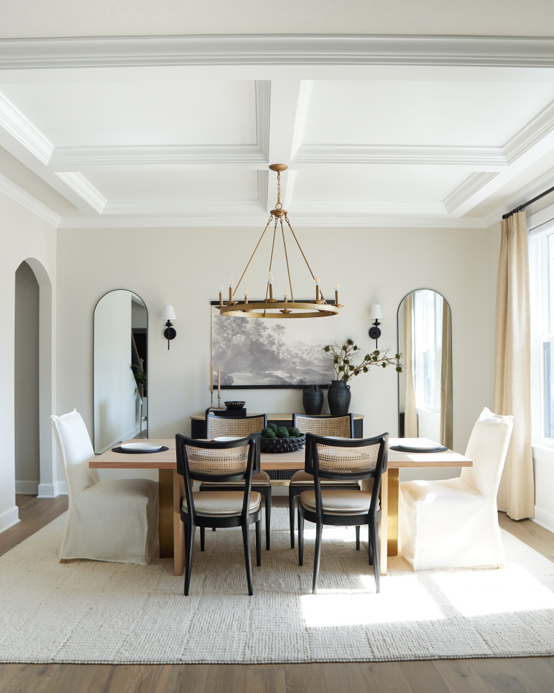 Example of a transitional medium tone wood floor, brown floor and coffered ceiling dining room design in Other with beige walls