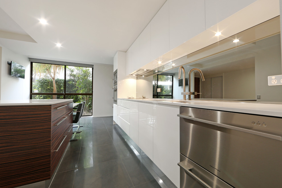 Inspiration for a mid-sized contemporary galley eat-in kitchen in Melbourne with an undermount sink, flat-panel cabinets, white cabinets, quartz benchtops, metallic splashback, mirror splashback, stainless steel appliances, porcelain floors and with island.