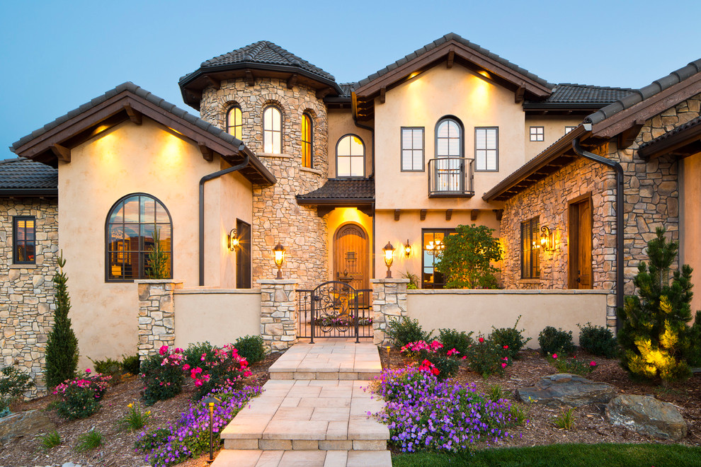 This is an example of a mediterranean two-storey beige exterior in Denver with a gable roof.