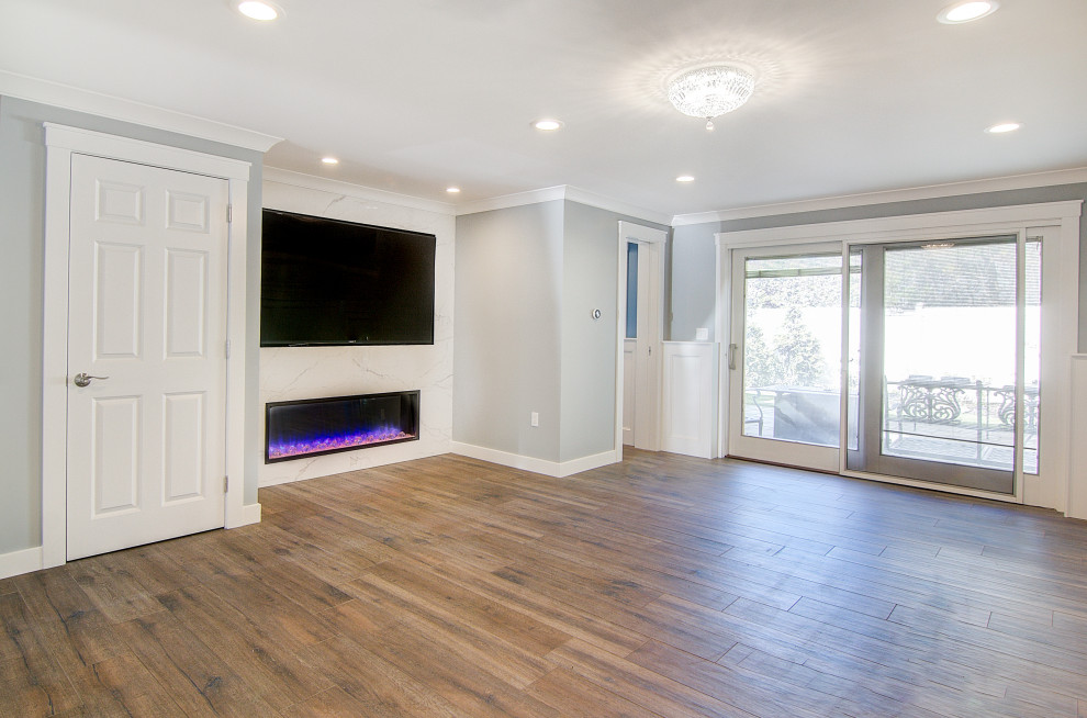 This is an example of a mid-sized modern enclosed family room in Other with grey walls, porcelain floors, a tile fireplace surround, a wall-mounted tv, brown floor and wood walls.