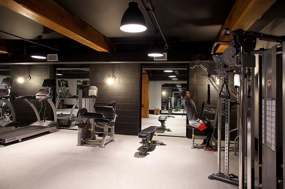 Inspiration for a mid-sized industrial home gym in New York with beige walls and beige floor.