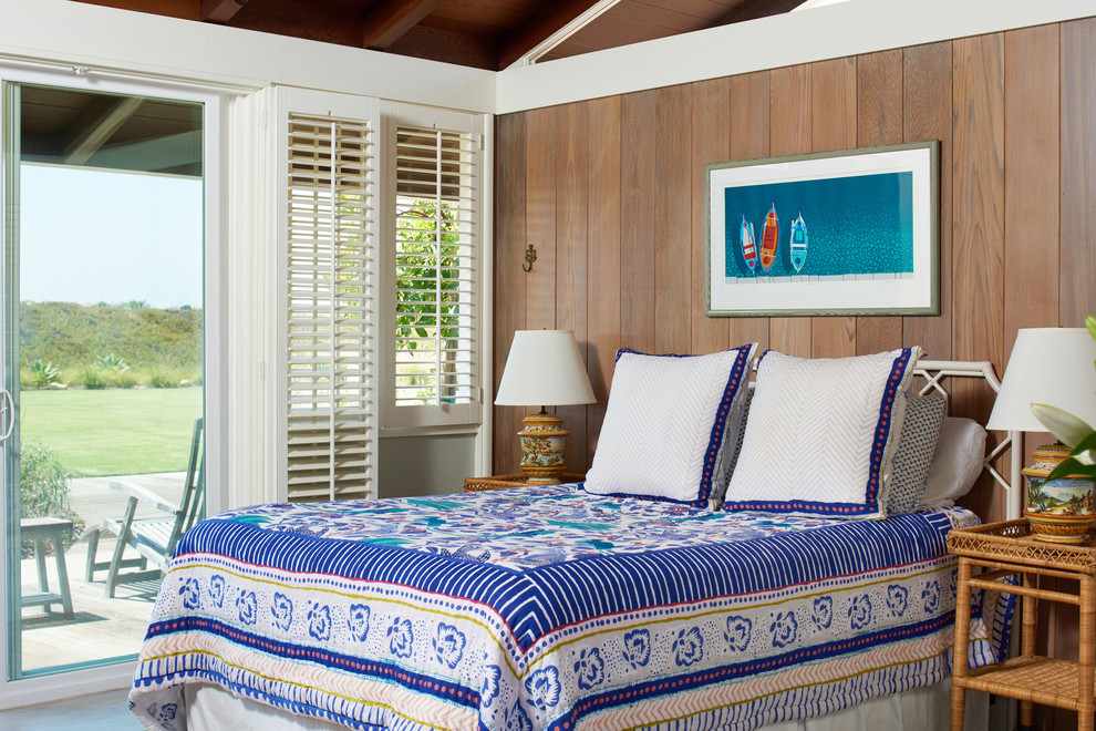 Design ideas for a mid-sized beach style guest bedroom in Santa Barbara with brown walls, vinyl floors, no fireplace and grey floor.