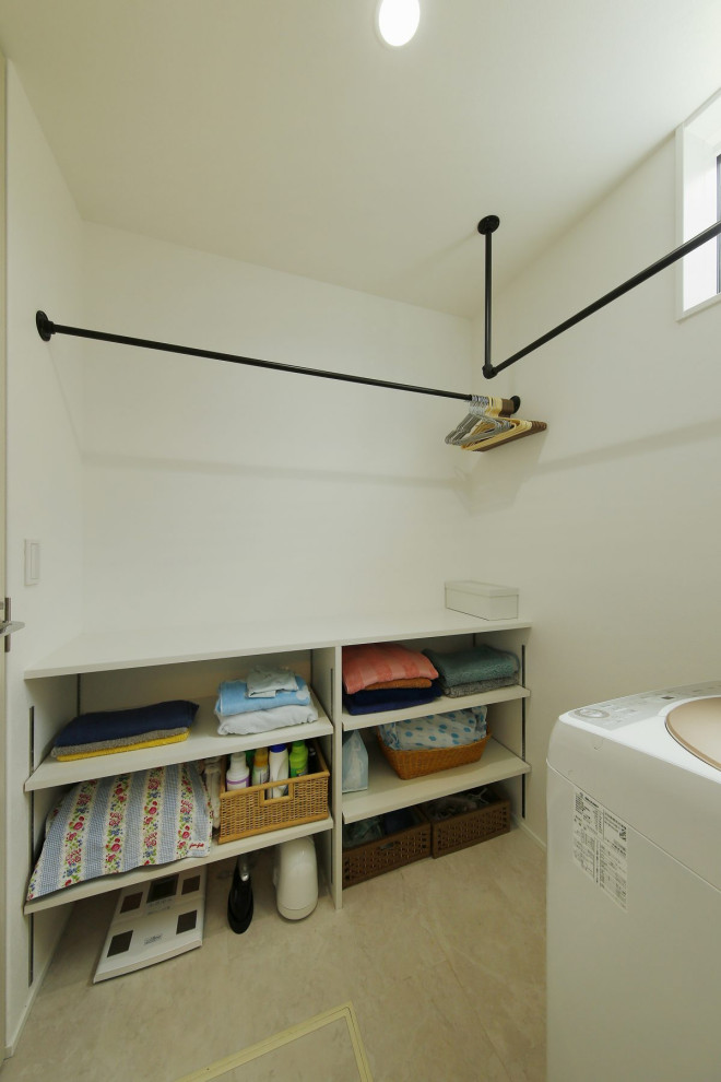 This is an example of a mid-sized industrial single-wall utility room in Tokyo Suburbs with open cabinets, white cabinets, wood benchtops, white benchtop, white walls, porcelain floors, beige floor, wallpaper and wallpaper.