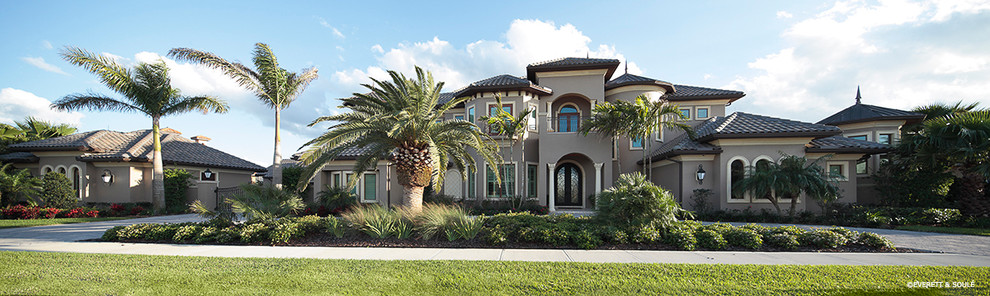 Design ideas for a mediterranean two-storey stucco beige house exterior in Orlando.