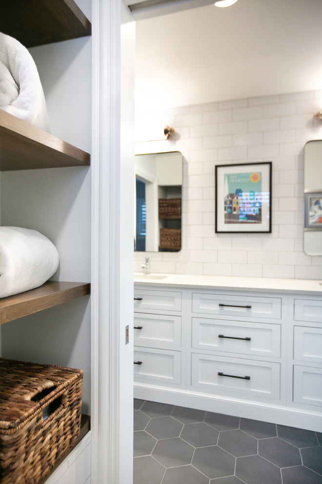 Inspiration for a transitional kids bathroom in Chicago with shaker cabinets, white cabinets, white tile, porcelain tile, white walls, porcelain floors, an undermount sink, marble benchtops, grey floor and white benchtops.