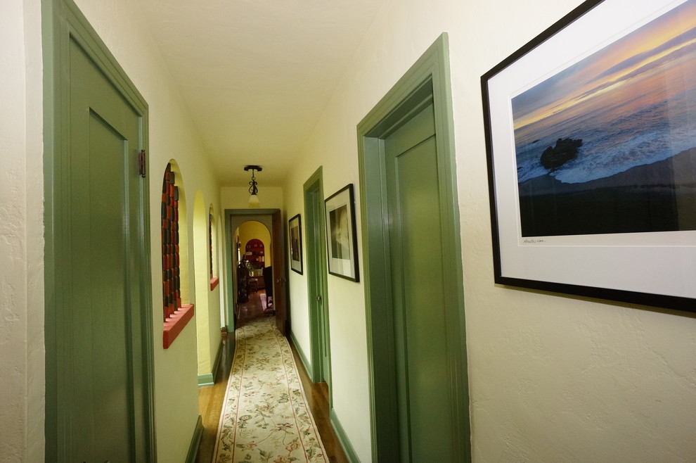 This is an example of a mid-sized traditional hallway in Los Angeles with white walls and medium hardwood floors.