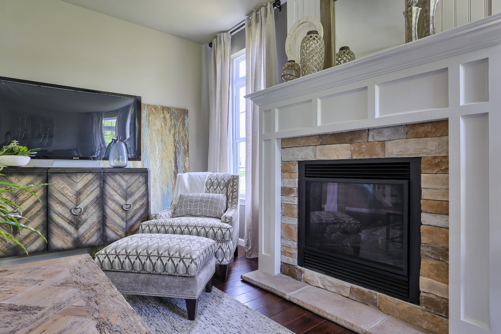 Photo of a mid-sized traditional open concept family room in Philadelphia with beige walls, dark hardwood floors, a standard fireplace, a stone fireplace surround and no tv.