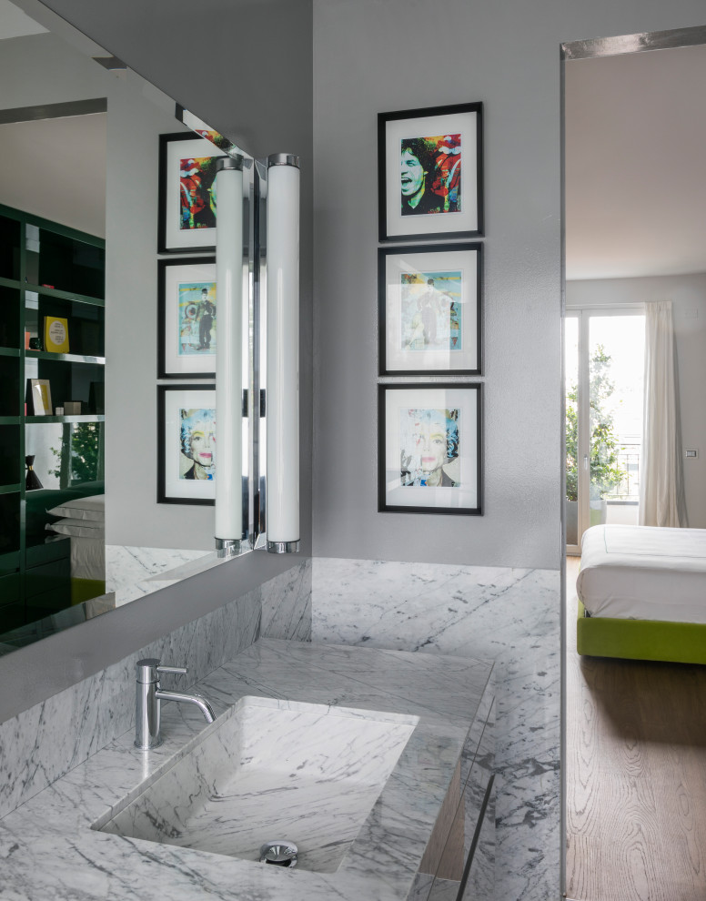 Design ideas for a large contemporary master bathroom in Milan with flat-panel cabinets, grey cabinets, a curbless shower, grey walls, marble floors, an integrated sink, marble benchtops, a hinged shower door, white benchtops, a double vanity and a floating vanity.