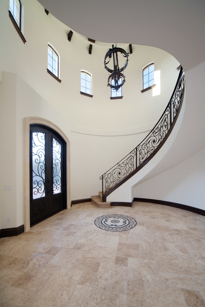 Inspiration for a large mediterranean foyer in Orlando with beige walls, travertine floors, a double front door and a black front door.