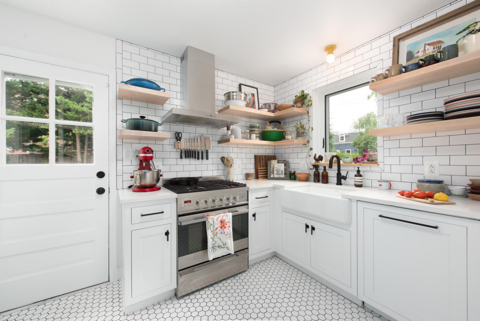 Lantlig inredning av ett litet vit vitt kök, med en rustik diskho, vita skåp, vitt stänkskydd, stänkskydd i tunnelbanekakel, rostfria vitvaror och vitt golv