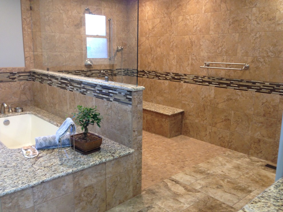 Example of a transitional master brown tile and porcelain tile corner shower design with an undermount tub