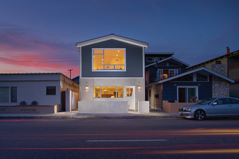 Inspiration for a small contemporary two-storey stucco blue exterior in Orange County with a gable roof.