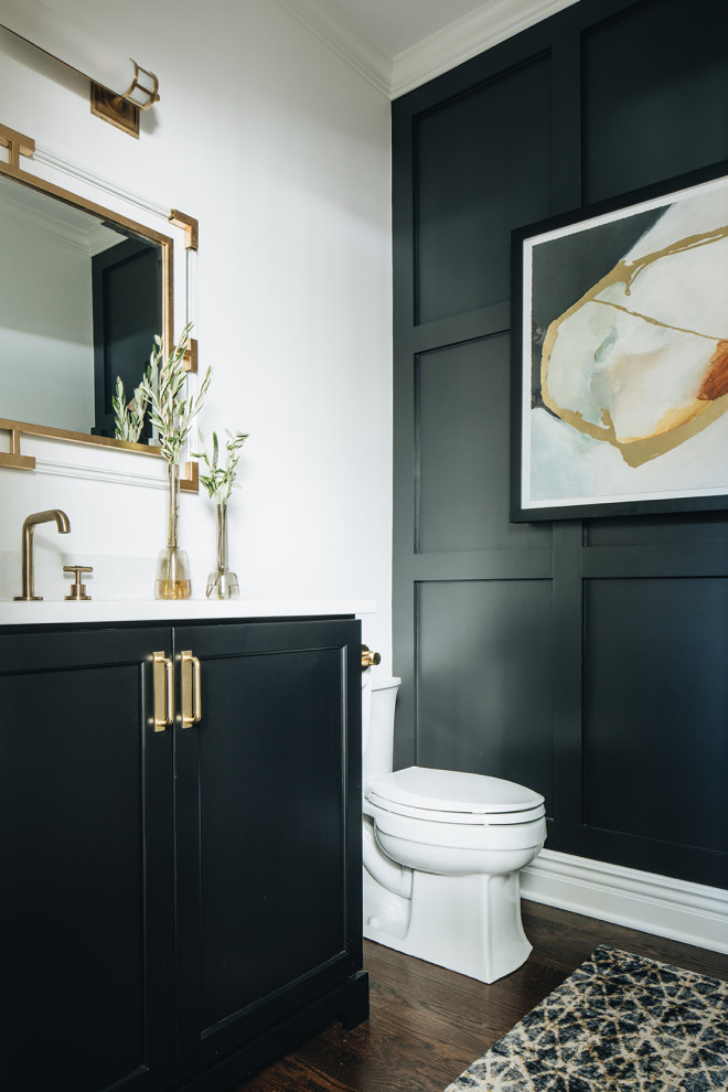 Example of a small transitional dark wood floor and brown floor bathroom design in Chicago with shaker cabinets, black cabinets, a two-piece toilet, white walls, an undermount sink, quartz countertops and white countertops