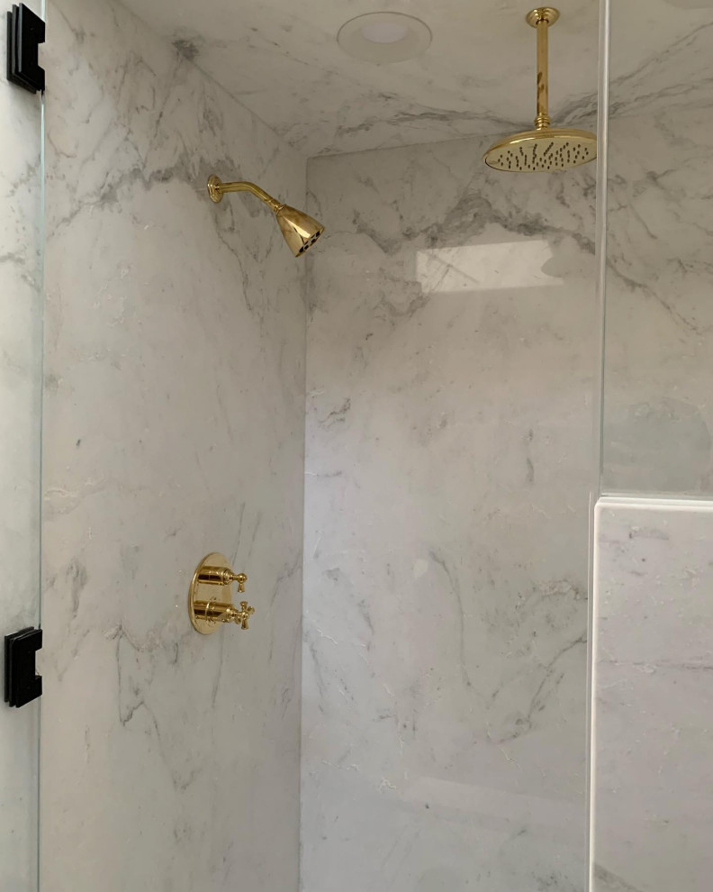 This is an example of a medium sized modern ensuite bathroom in Orange County with all types of shower, white tiles, marble tiles, white walls, light hardwood flooring, marble worktops, a hinged door, white worktops and a shower bench.