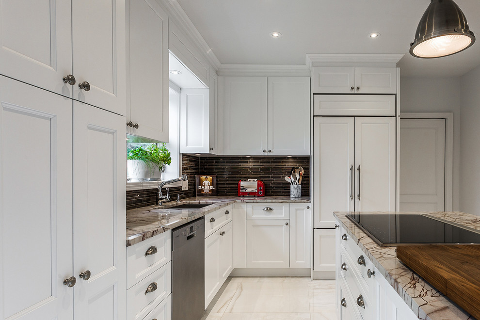 Open concept kitchen - mid-sized transitional l-shaped white floor open concept kitchen idea with an undermount sink, white cabinets, brown backsplash and an island