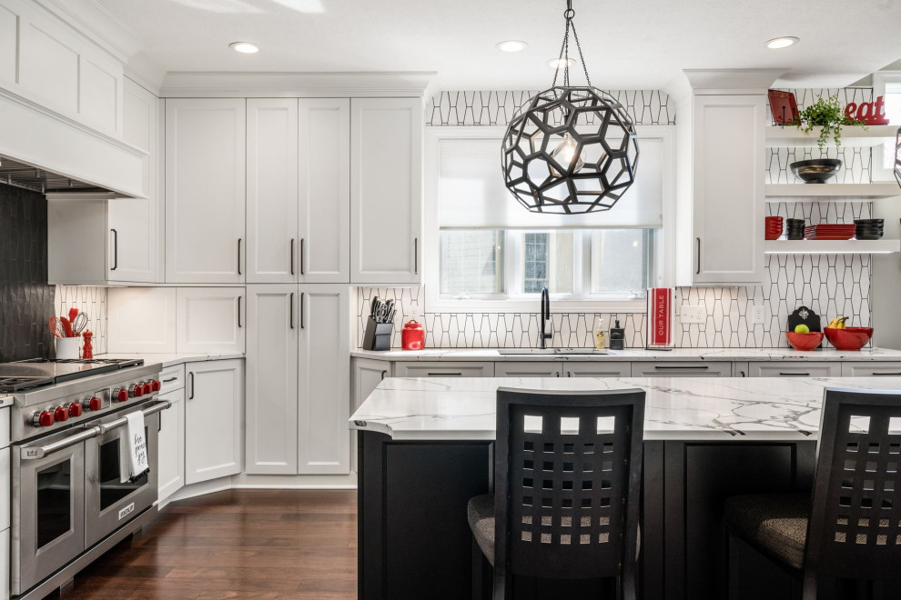 This is an example of a transitional eat-in kitchen in Columbus with a single-bowl sink, beaded inset cabinets, white cabinets, marble benchtops, white splashback, ceramic splashback, dark hardwood floors, with island, brown floor and white benchtop.