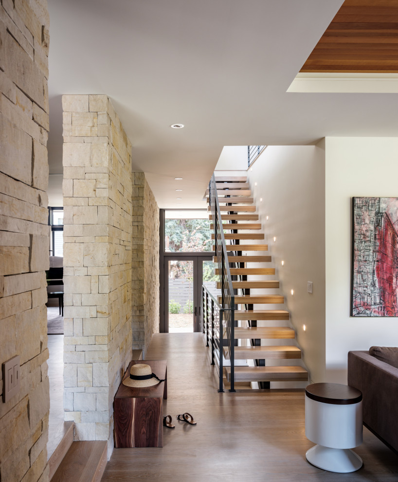 Mid-sized minimalist wooden floating open and metal railing staircase photo in Denver