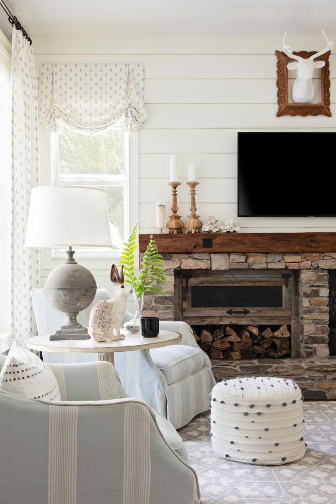 Design ideas for a mid-sized country open concept family room in Orlando with grey walls, medium hardwood floors, a standard fireplace, a stone fireplace surround, planked wall panelling and brown floor.