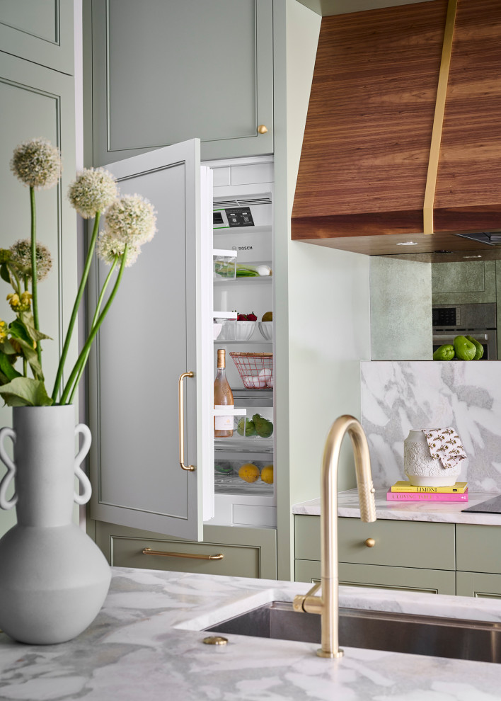 Mid-sized transitional galley medium tone wood floor and brown floor open concept kitchen photo in Atlanta with an undermount sink, recessed-panel cabinets, green cabinets, marble countertops, white backsplash, marble backsplash, paneled appliances, an island and white countertops
