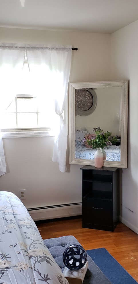 Example of a cottage chic bedroom design in New York