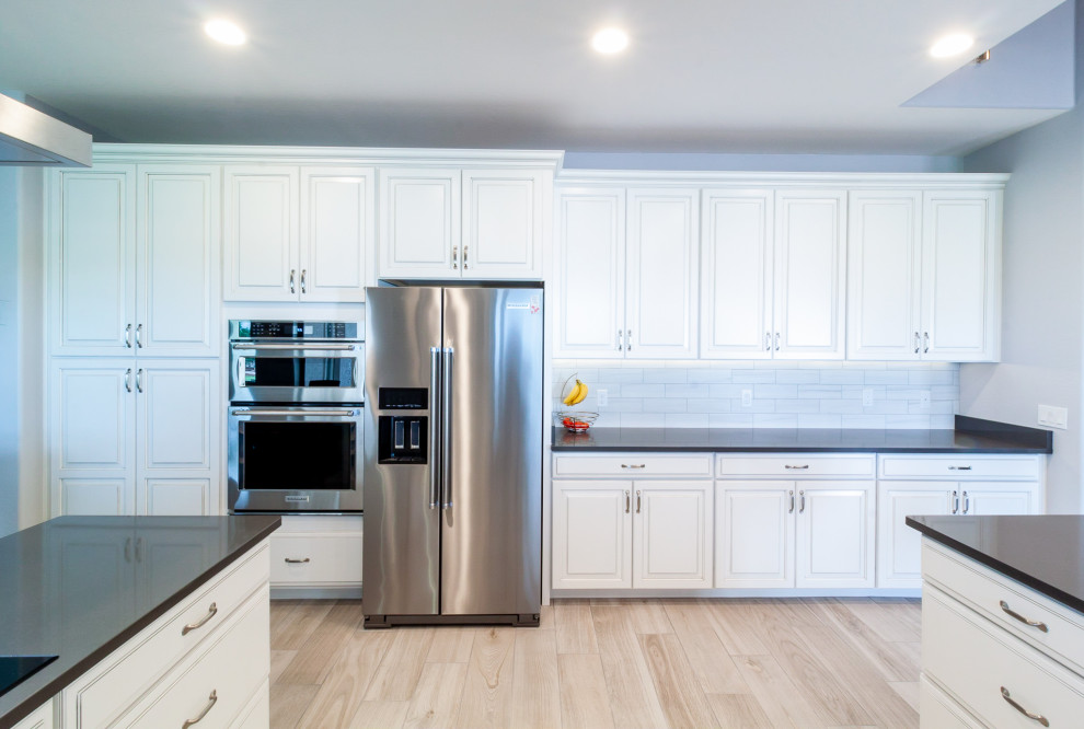 Porcelain tile kitchen photo in Phoenix with quartzite countertops