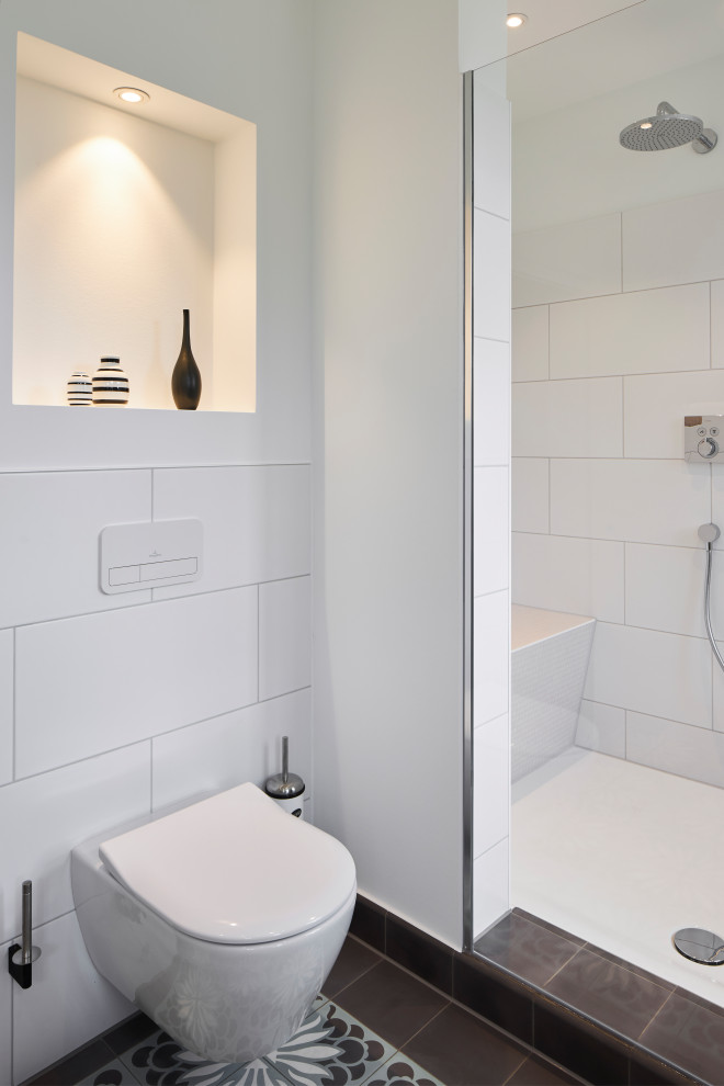 Foto di una stanza da bagno chic con doccia aperta, WC sospeso, piastrelle bianche, pareti bianche, pavimento in cementine e panca da doccia