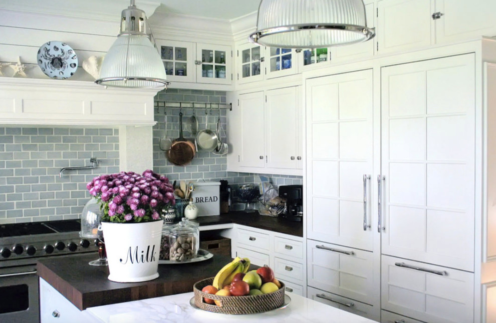 Inspiration for a mid-sized transitional l-shaped enclosed kitchen remodel in Vancouver with shaker cabinets, white cabinets, solid surface countertops, gray backsplash, ceramic backsplash, paneled appliances and an island