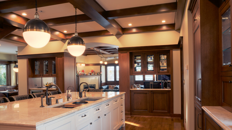 Design ideas for a mid-sized traditional l-shaped open plan kitchen in Chicago with an undermount sink, recessed-panel cabinets, medium wood cabinets, medium hardwood floors and with island.