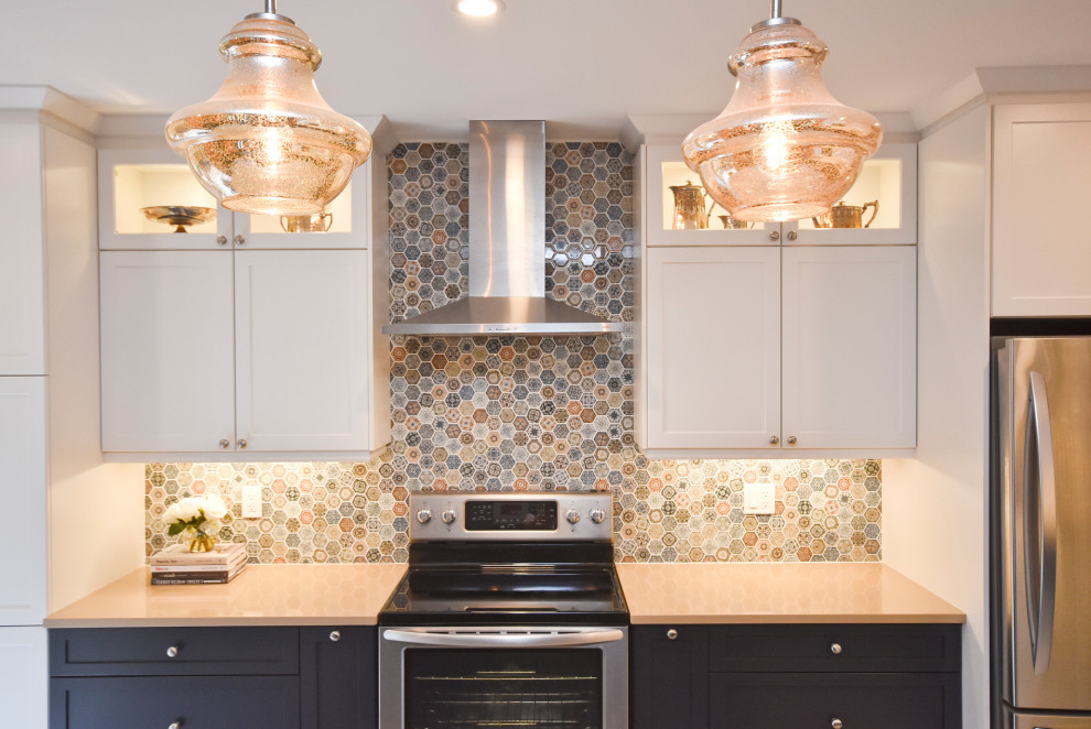 Kitchen - mid-sized transitional l-shaped vinyl floor and beige floor kitchen idea in Ottawa with a double-bowl sink, shaker cabinets, white cabinets, quartzite countertops, multicolored backsplash, mosaic tile backsplash, stainless steel appliances, an island and beige countertops
