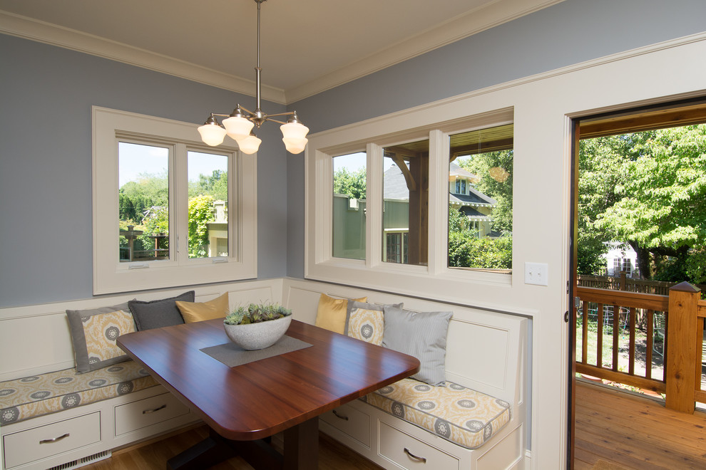 This is an example of a mid-sized traditional kitchen/dining combo in Portland with light hardwood floors.