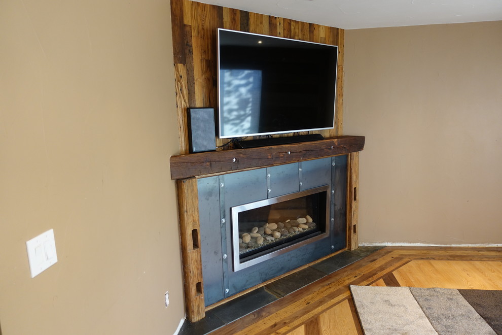 Small mountain style open concept medium tone wood floor home design photo in Denver with beige walls, a corner fireplace and a metal fireplace