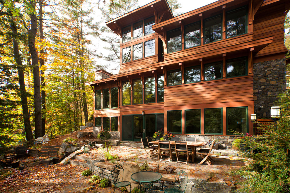 This is an example of a country three-storey exterior in New York with wood siding.