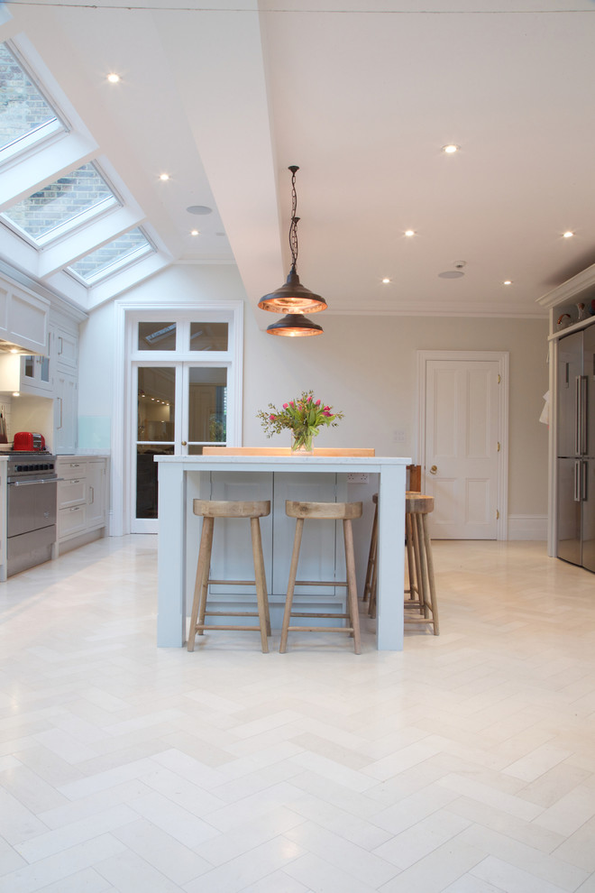 Traditional kitchen in London with limestone floors.