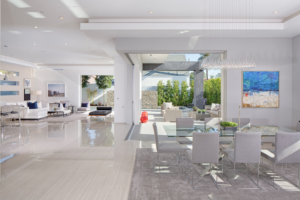Photo of an expansive contemporary open plan dining in Los Angeles with white walls and porcelain floors.