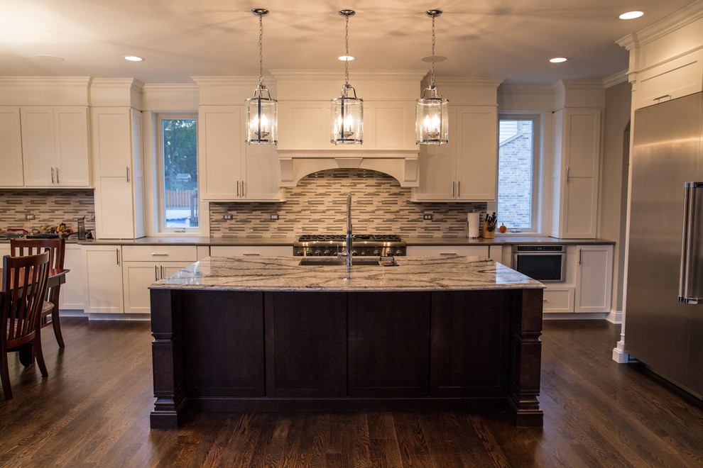 Example of a large transitional single-wall dark wood floor eat-in kitchen design in Chicago with an undermount sink, shaker cabinets, white cabinets, marble countertops, multicolored backsplash, matchstick tile backsplash, stainless steel appliances and an island