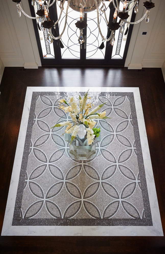 Inspiration for a large transitional marble floor foyer remodel in Toronto with white walls