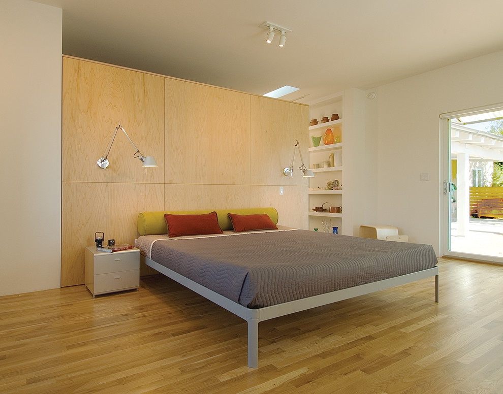 Inspiration for a large scandinavian master light wood floor bedroom remodel in Albuquerque with white walls and no fireplace