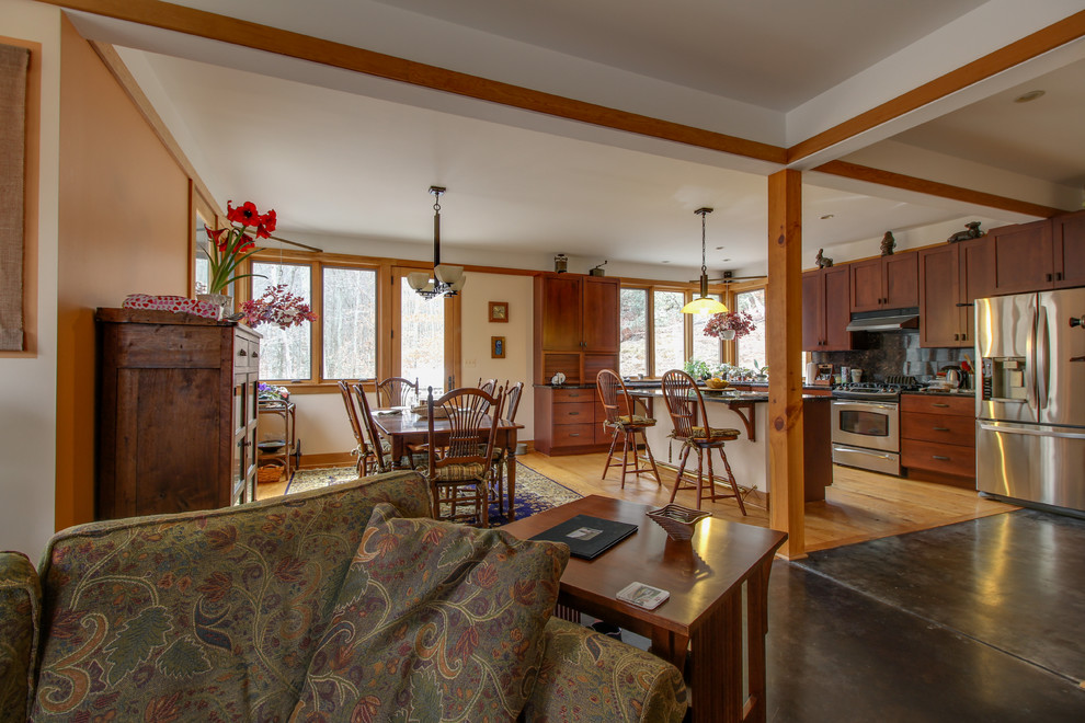 Eat-in kitchen - mid-sized transitional l-shaped medium tone wood floor and brown floor eat-in kitchen idea with shaker cabinets, dark wood cabinets, quartz countertops, gray backsplash, ceramic backsplash, stainless steel appliances, an island and black countertops
