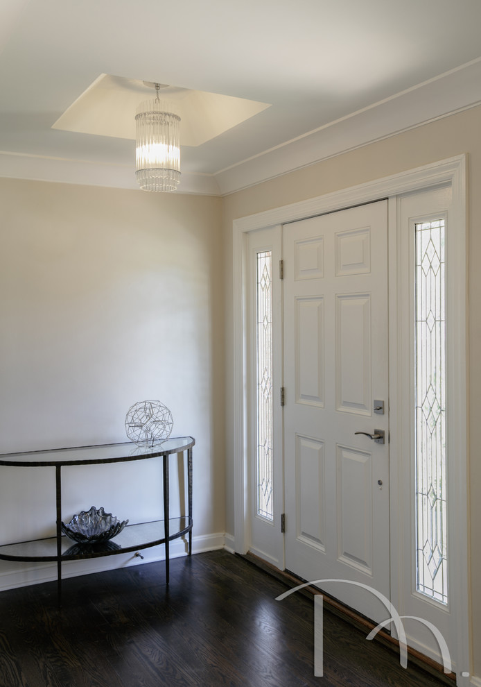 Inspiration for a transitional front door with beige walls, dark hardwood floors, a single front door and a white front door.