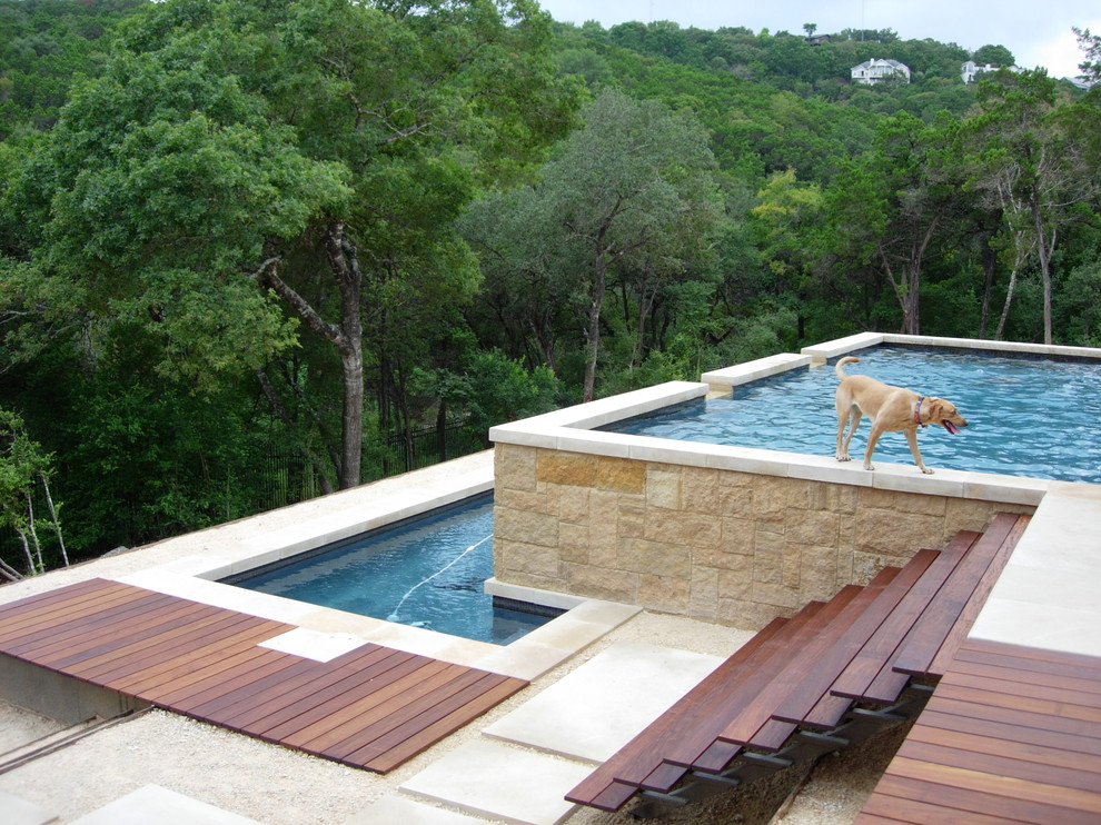 Contemporary pool in Austin with decking.