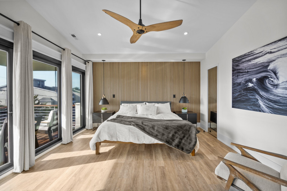 Esempio di una grande camera da letto costiera con pareti bianche, pavimento beige, soffitto a volta e pareti in legno