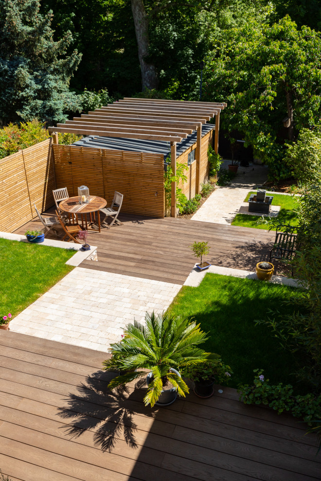 Exemple d'un jardin avec pergola avant chic de taille moyenne et l'été avec une exposition ensoleillée et une terrasse en bois.