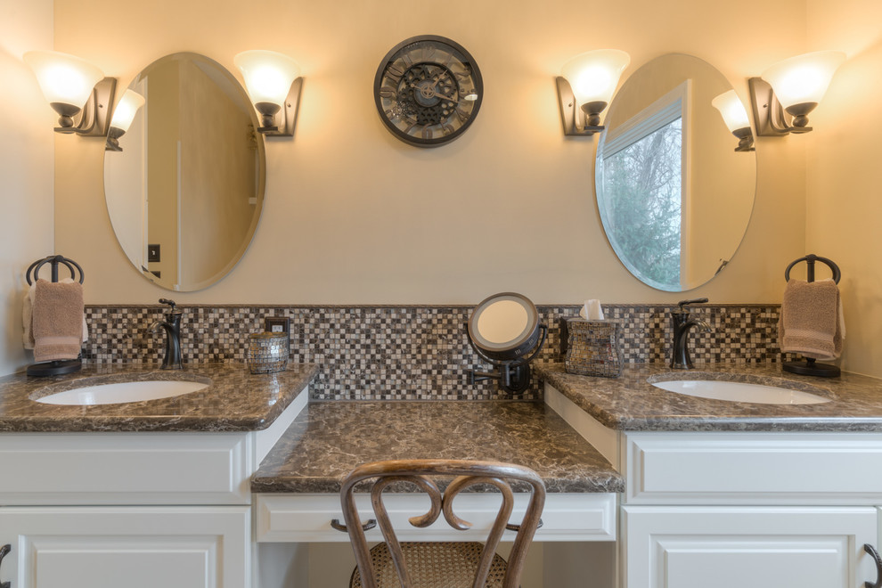 Doorless shower - mid-sized transitional master multicolored tile ceramic tile doorless shower idea with raised-panel cabinets, beige cabinets, a two-piece toilet, beige walls, an undermount sink and quartz countertops